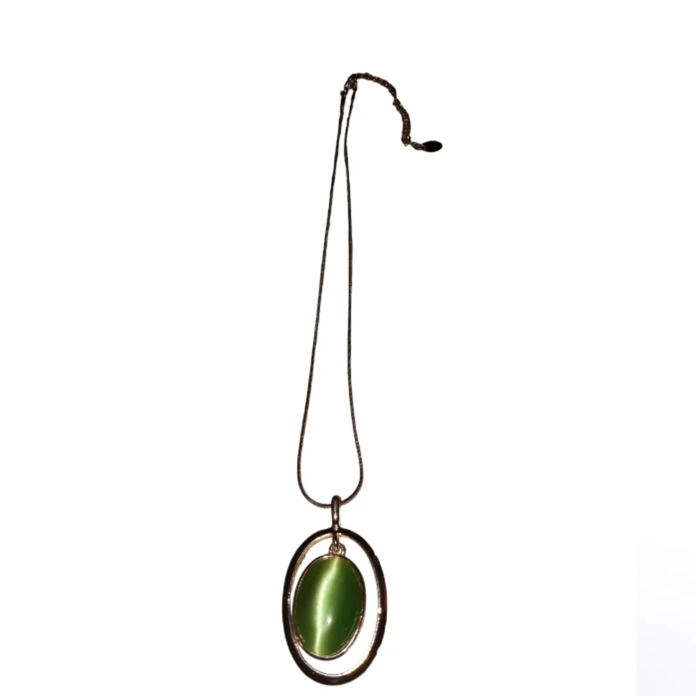 Claire's silver necklace with a green cat's eye pendant